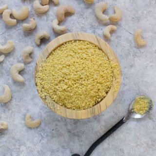 Vegan parm seasoning in a bowl with a spoon.