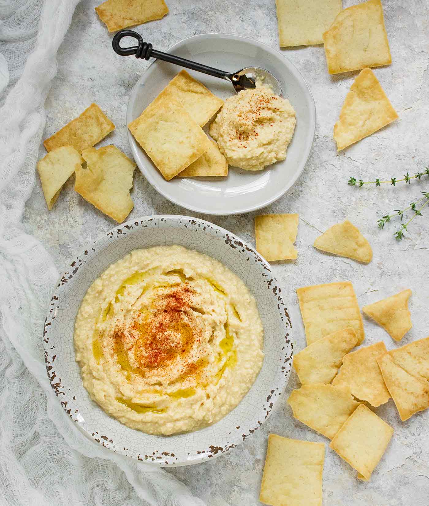 A table spread featuring smoked corn hummus and pita chips