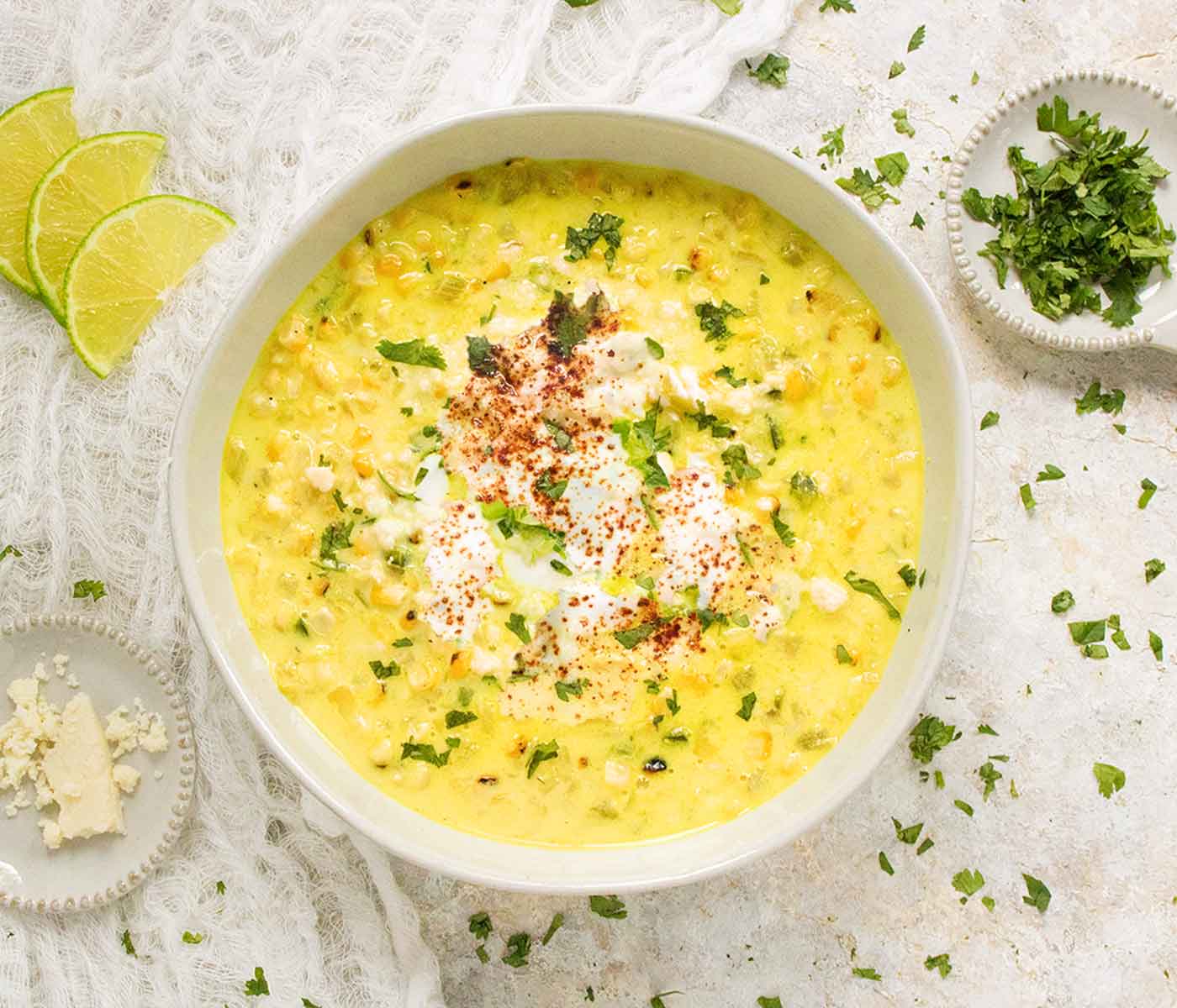 An overhead view of Mexican Street Corn Soup in a light colored bowl.