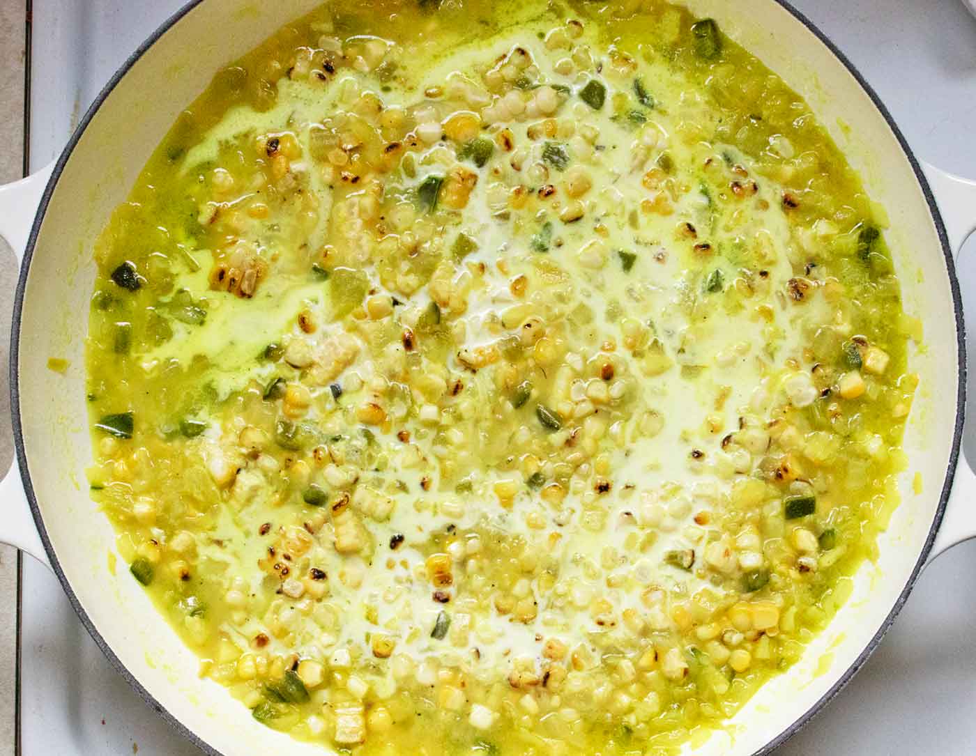 Finishing the soup by adding the cream and cheese.