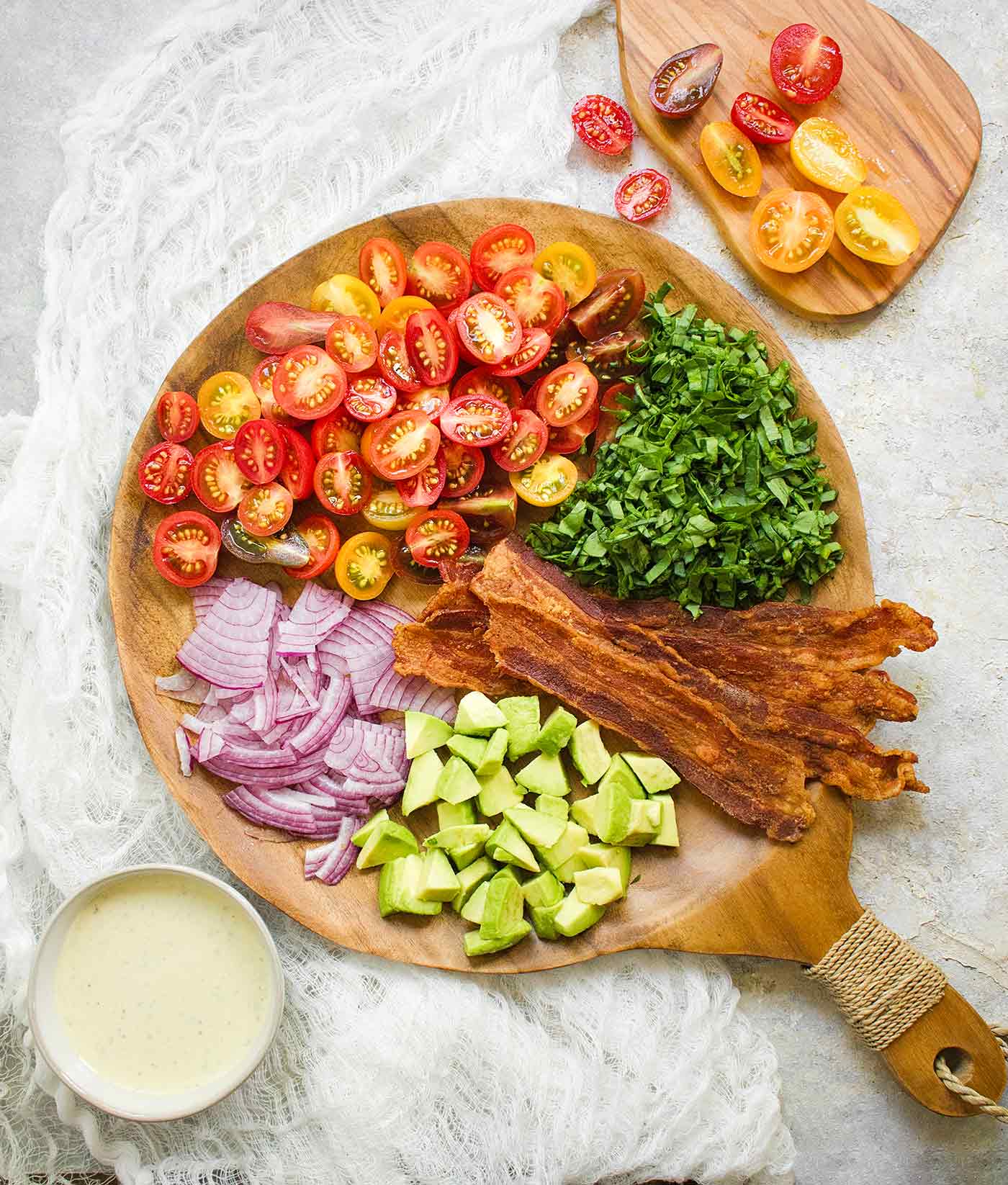 Ingredients for BLT Pasta Salad arranged on a wooden serving board