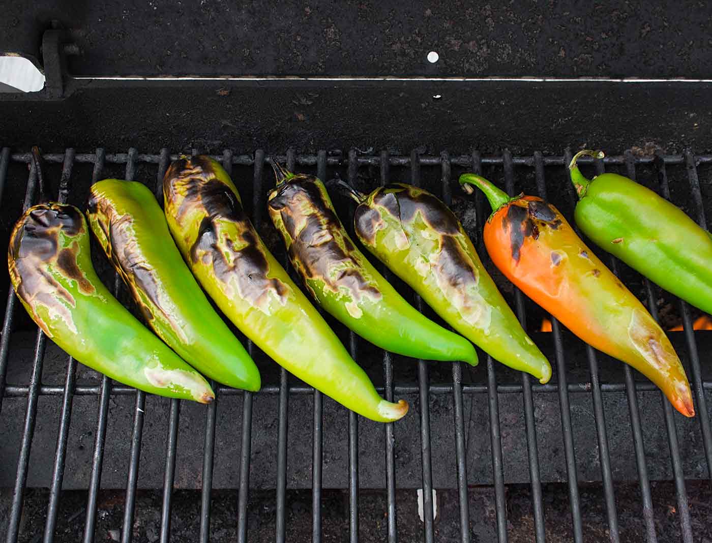 Hatch chiles roasting on the grill