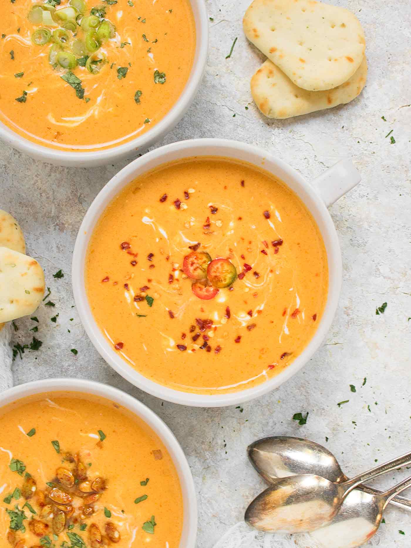 Close up of bowl of Thai Pumpkin Soup with crushed red pepper topping