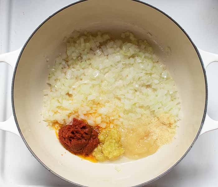 Saute the onions in some oil, and bloom the seasonings in the heat of the pan.