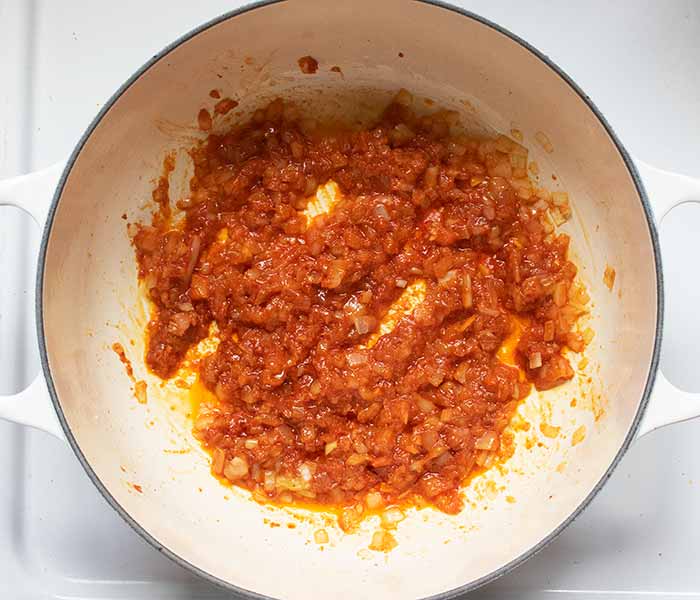 Cooking the onion mixture until thick and fragrant.