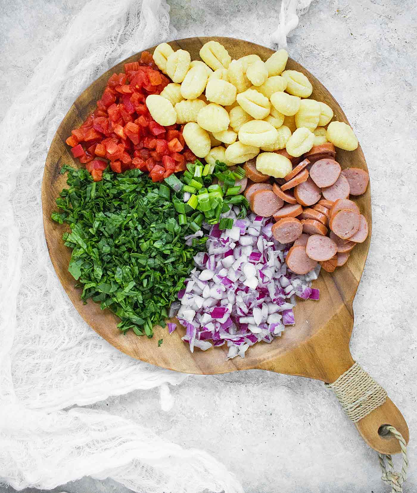 Ingredients for Smoke Sausage & Gnocchi on a wooden board
