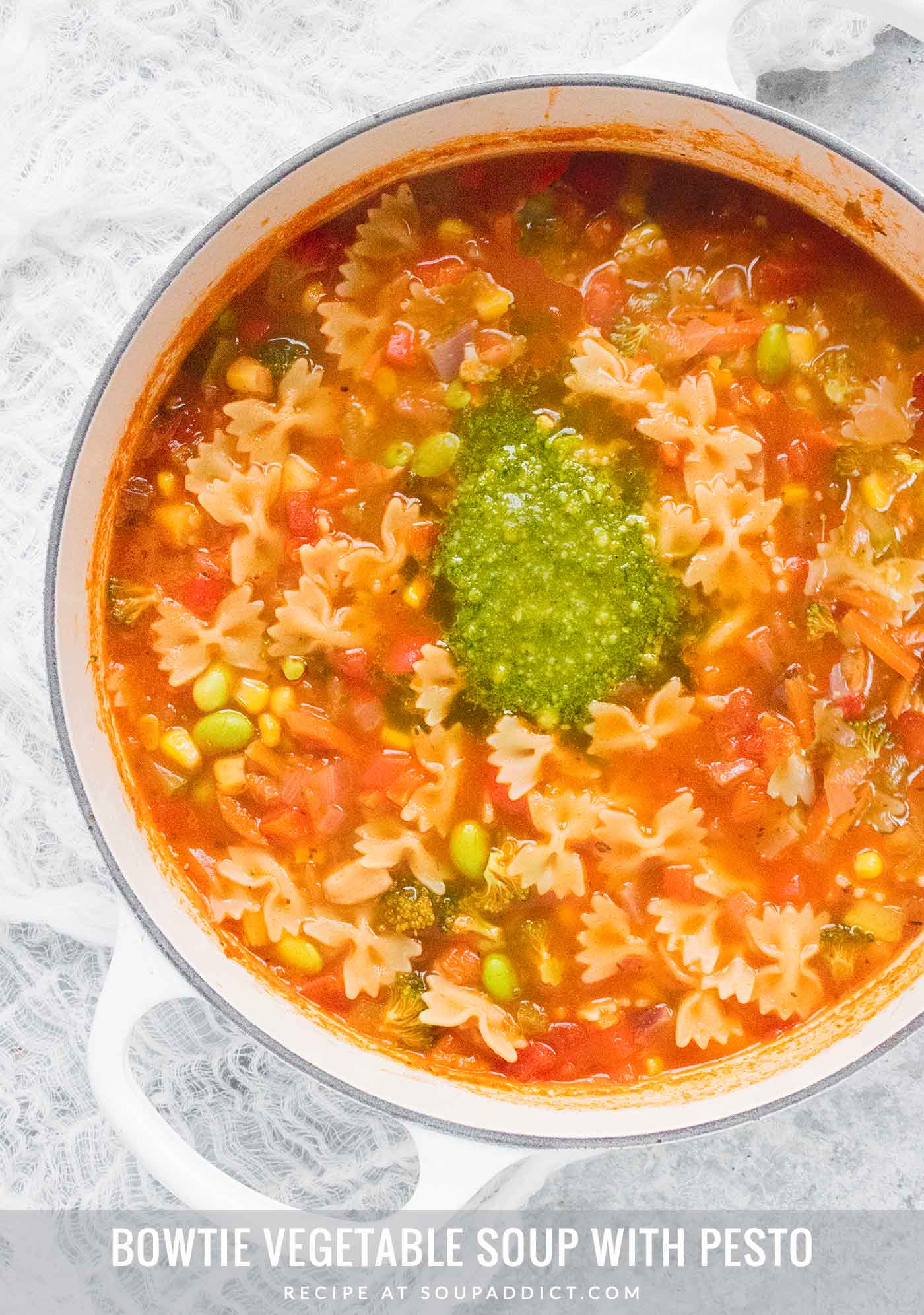 Bowtie Vegetable Soup with Pesto in a large white Dutch oven