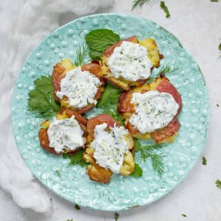 Crispy, smashed potatoes on a blue plate