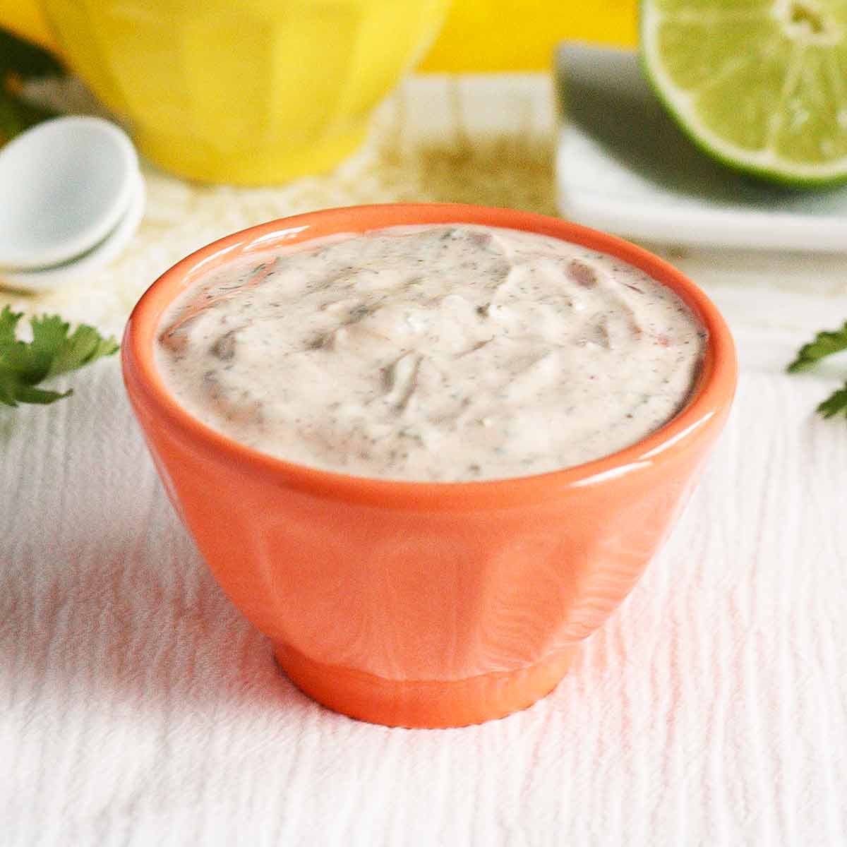 Close-up of Wickedly Good Fish Taco Sauce in an orange serving bowl.