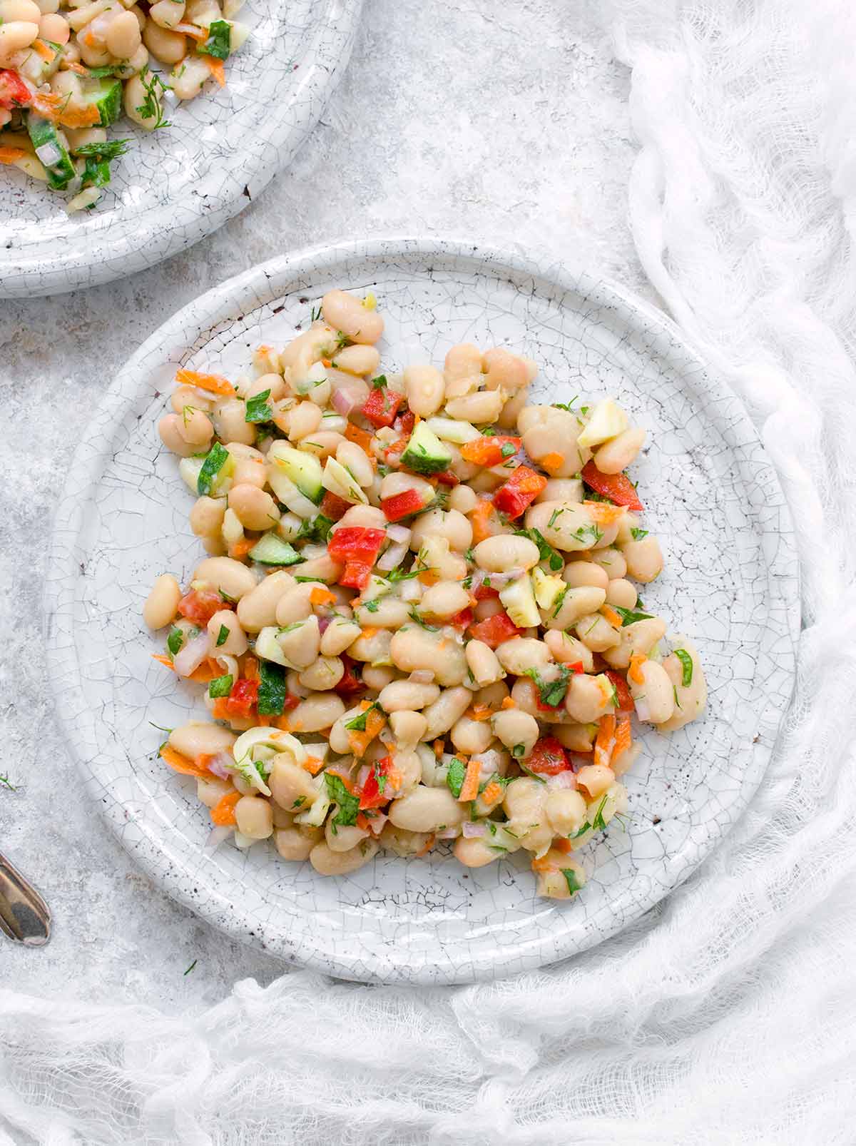 Two plates of herbed white bean picnic salad