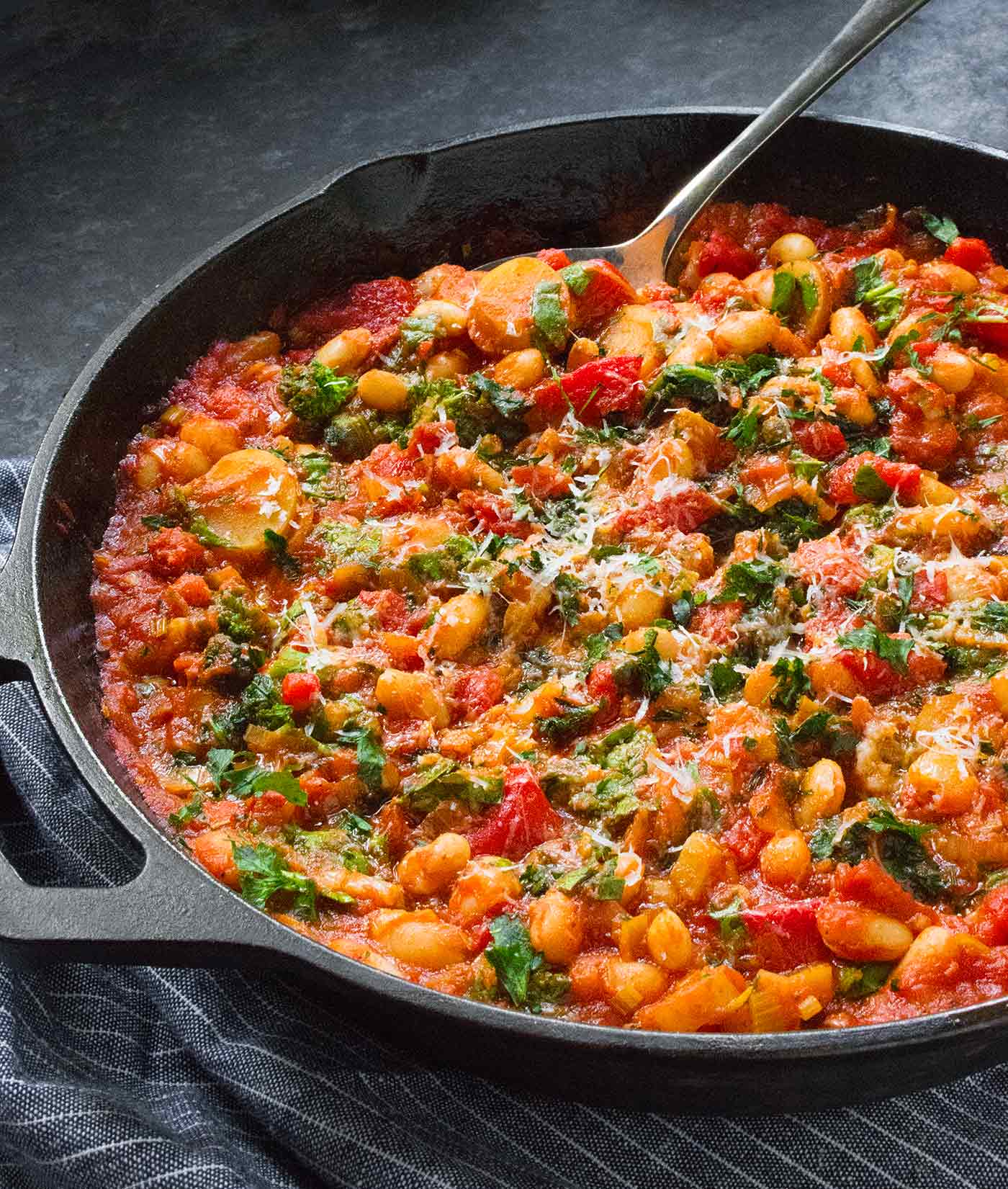 Angled view of Mediterranean White Bean Recipe in a cast iron skillet