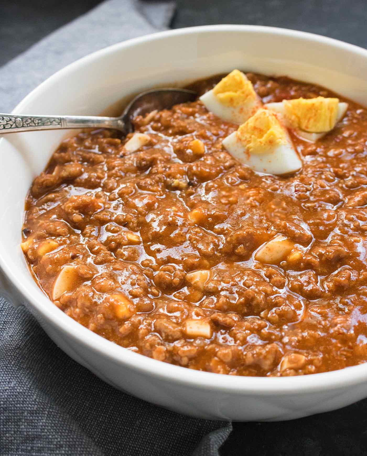 Angled view of Mock Turtle Soup in a white bowl with a spoon