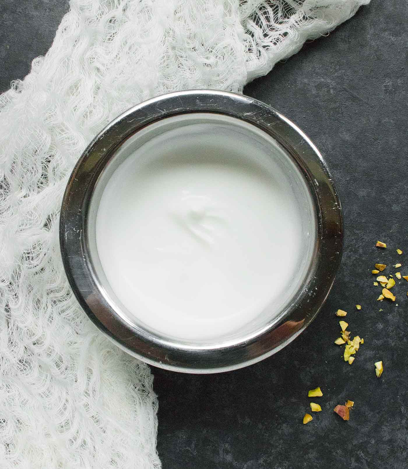 A bowl of creamy coconut milk that has been whipped with feta cheese