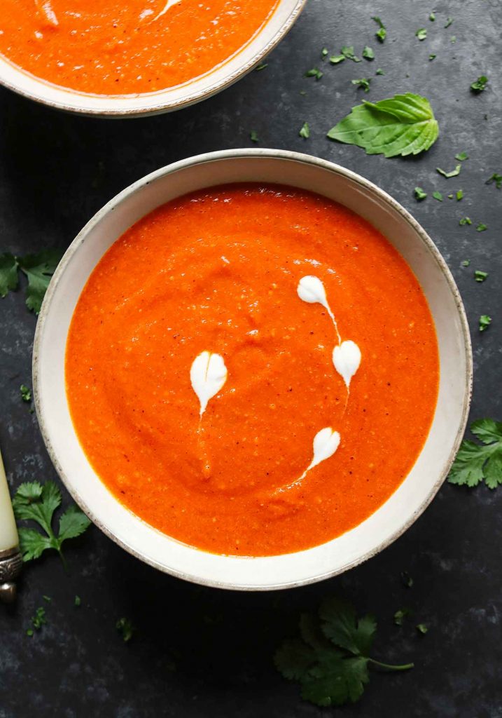 A grey bowl of Sheet Pan Roasted Red Pepper and Tomato Soup.