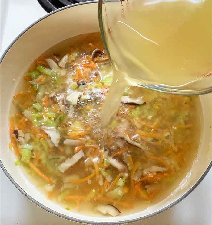 Pour in the chicken broth.