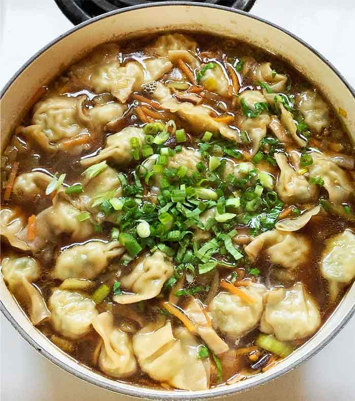 When the potstickers are cooked through, add the green onions and cilantro to the soup.