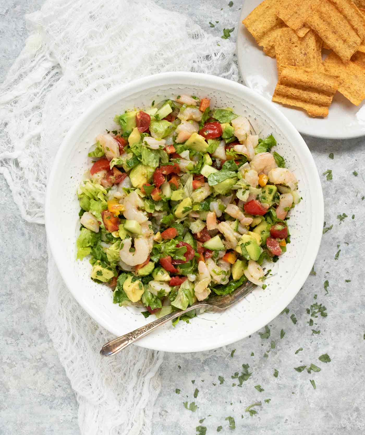 Avocado Shrimp Salsa Salad in a white serving bowl with a side of chips.