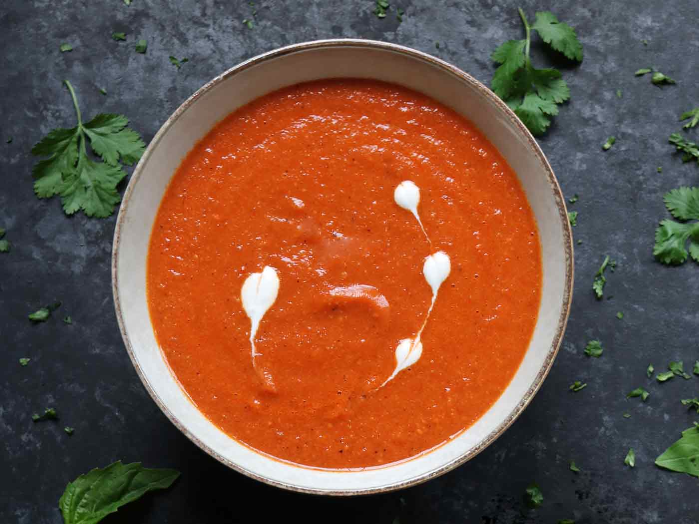 Overhead view of a bowl of Sheet Pan Roasted Red Pepper and Tomato Soup.