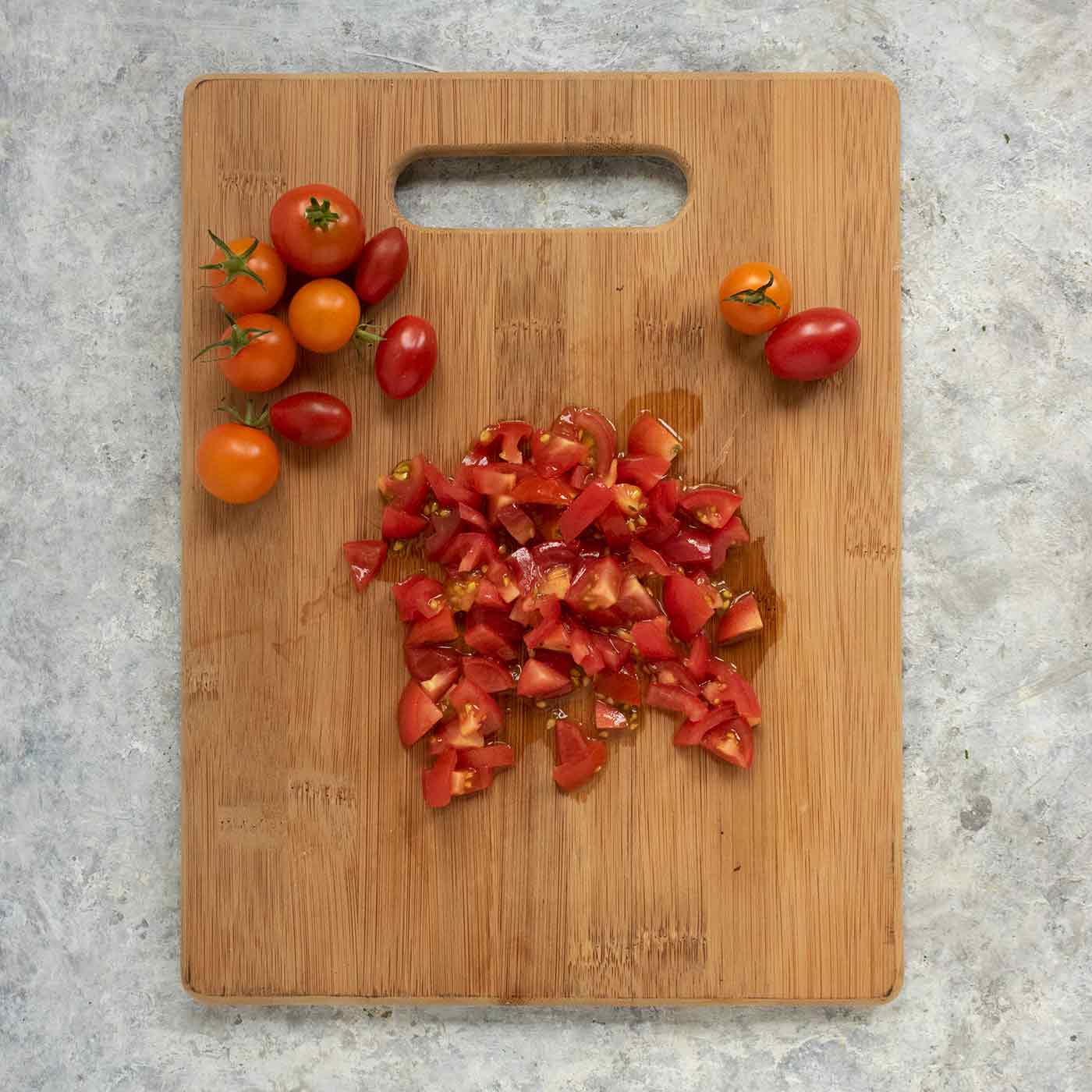 Chopped tomatoes on a cutting board.