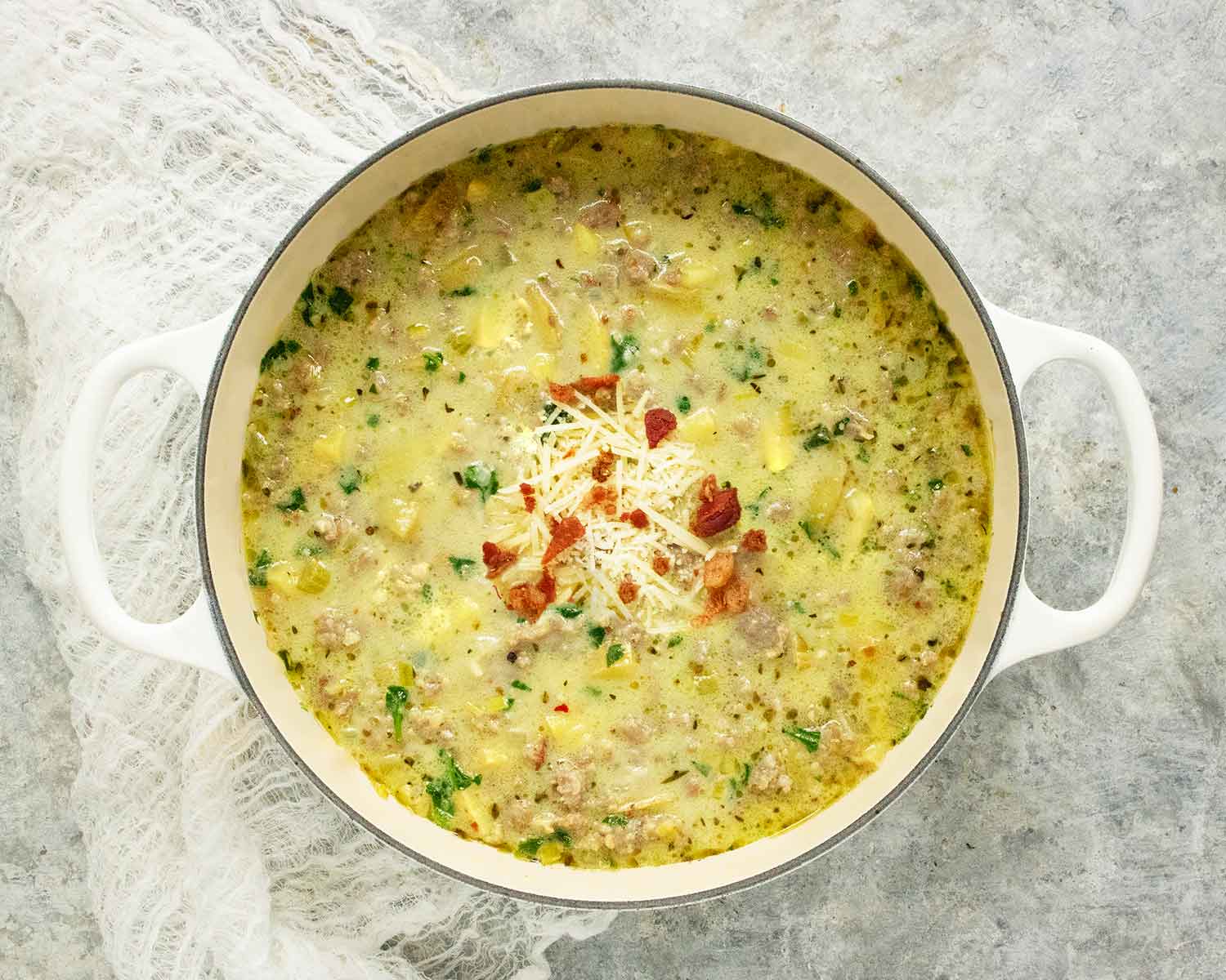 Tuscan Potato Soup in a large white Dutch oven.