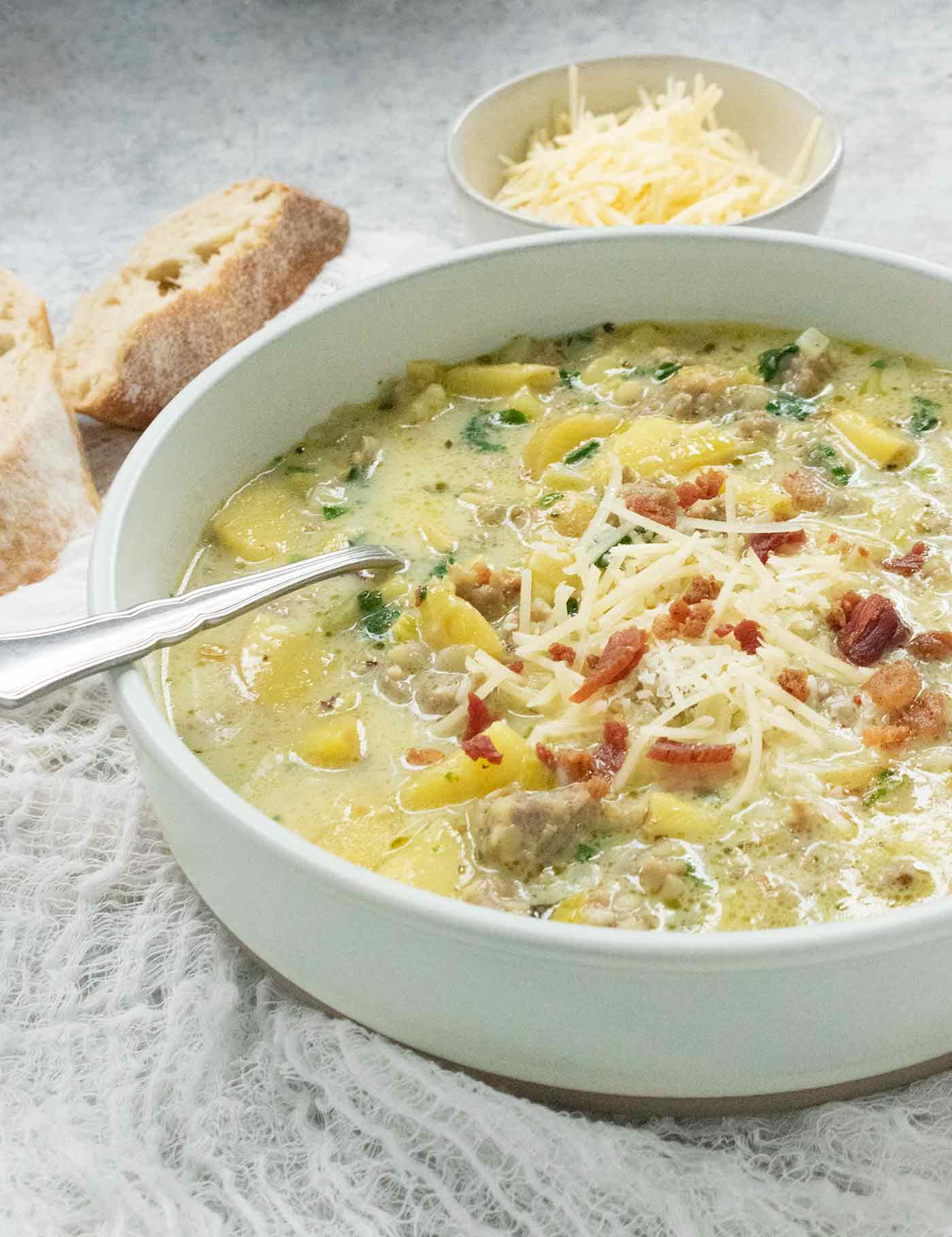 Side angled view of potato soup in a bowl.