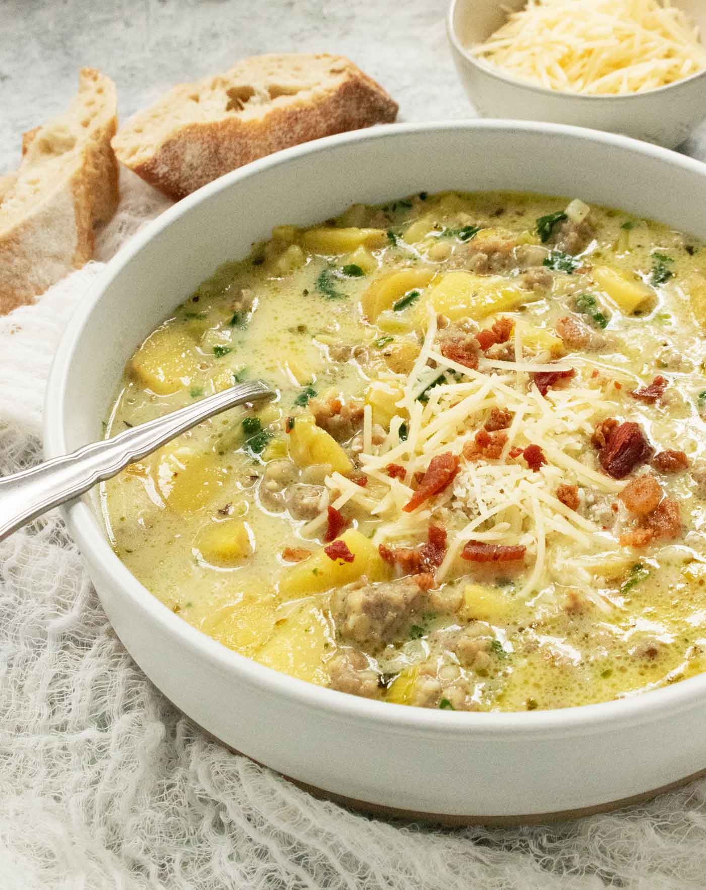 Side view of a bowl of Tuscan Potato Soup.