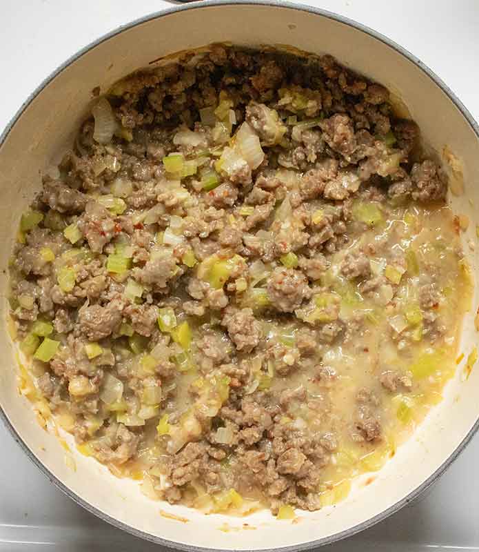 Building the soup base with the meat and vegetables.