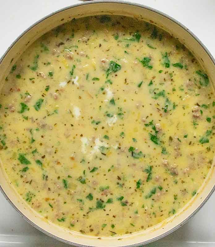 Finishing the soup with a little cream.