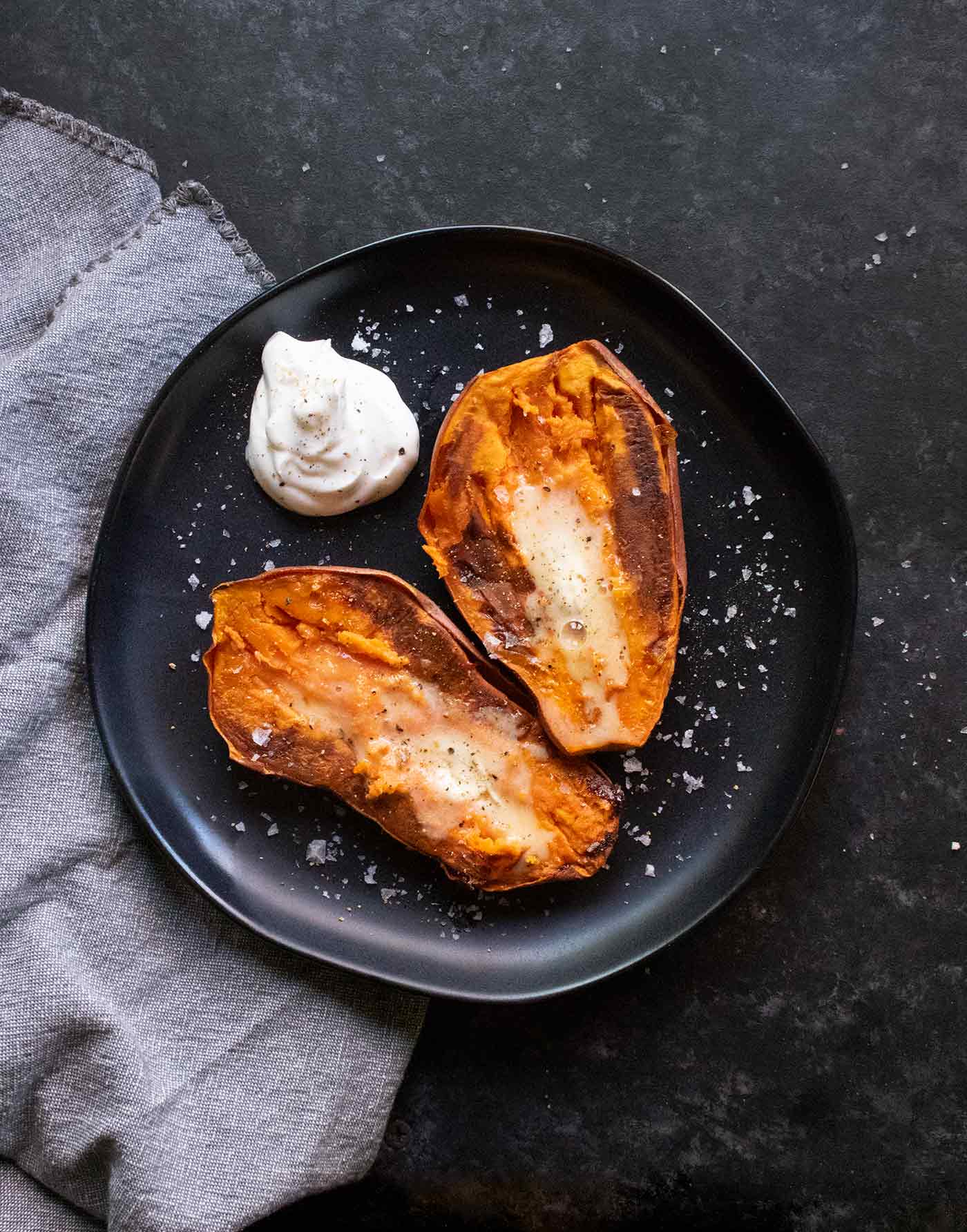 Two sweet potato halves on a plate.