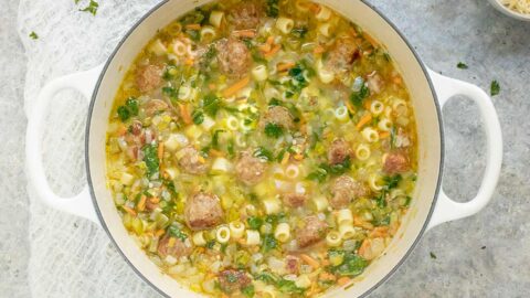 Italian Wedding Soup in a large white Dutch oven.