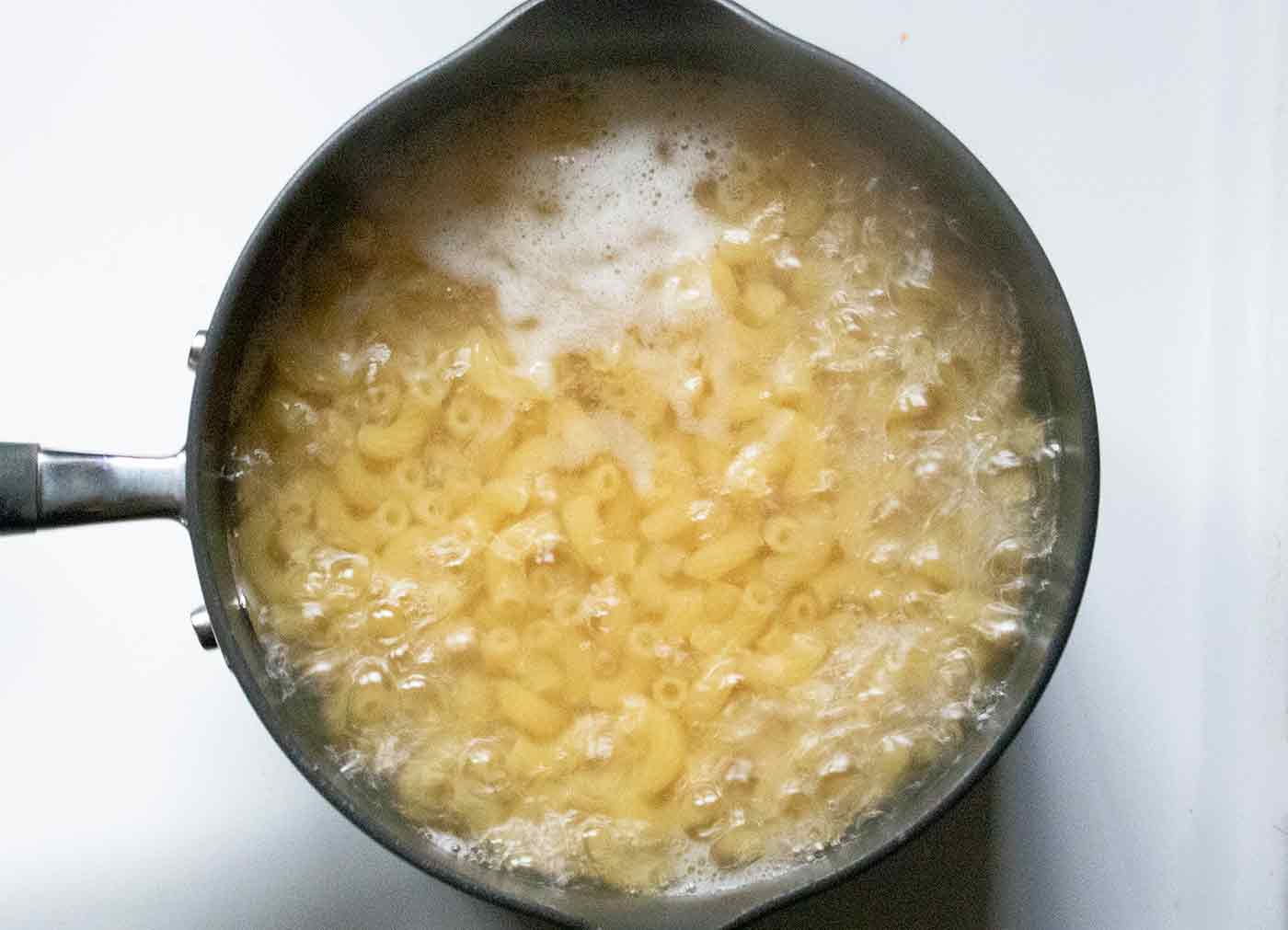 Overhead shot of pasta in boiling water.