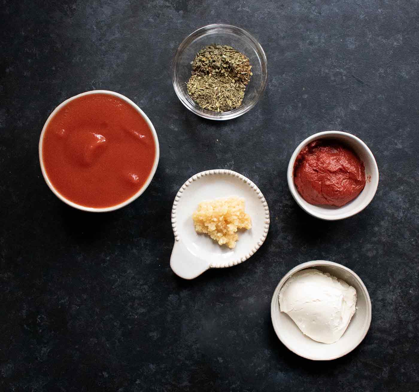 Seasoning ingredients for Creamy Tomato Soup in small pinch bowls.