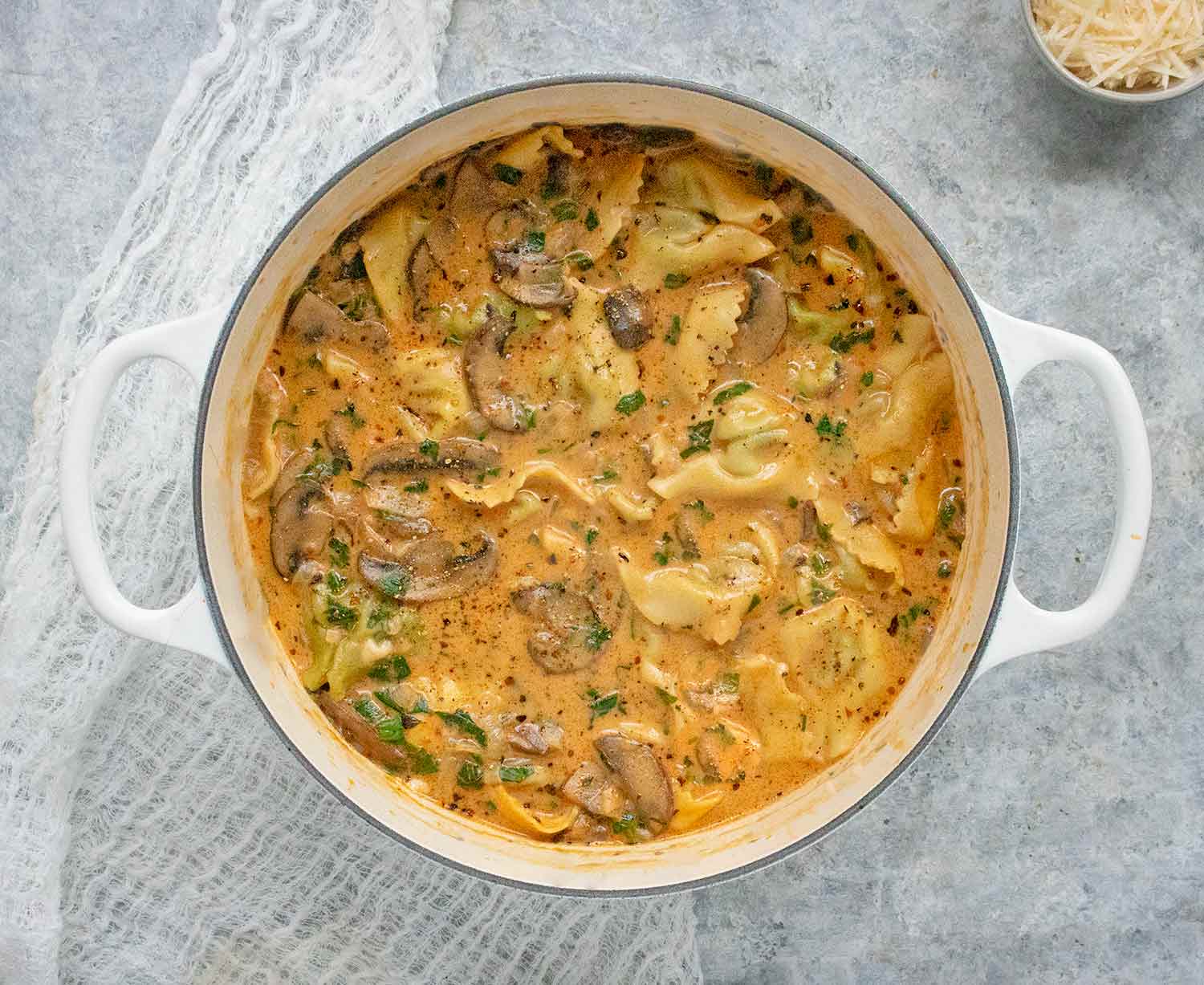 Creamy Mushroom Tortellini Soup in a large white Dutch oven.