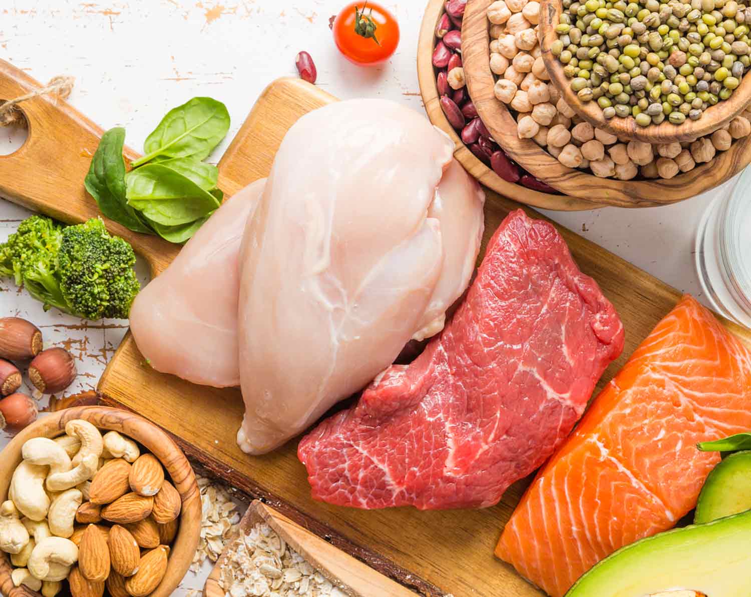 A variety of meats on a cutting board.