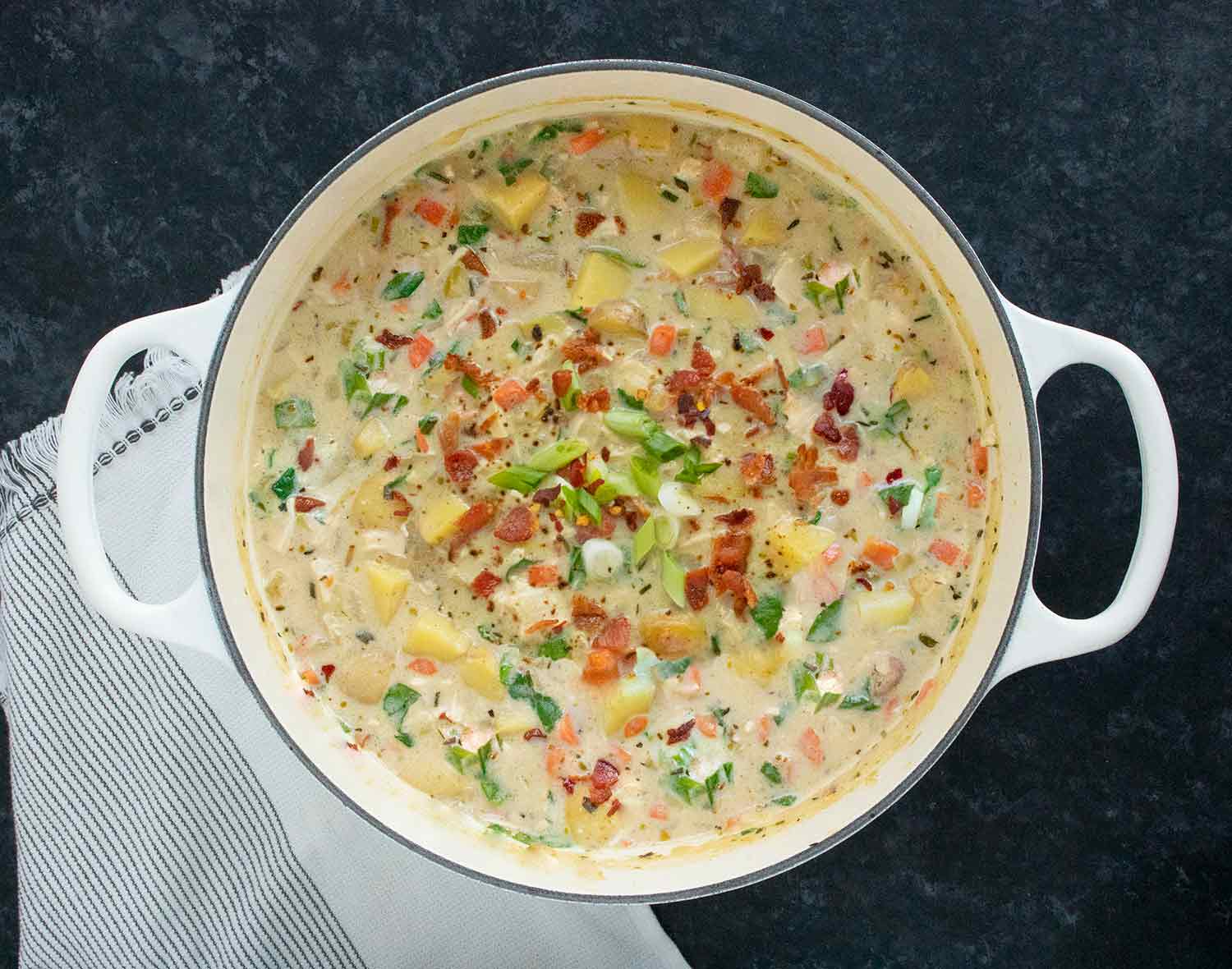Chicken Potato Soup with Bacon in a large white Dutch oven