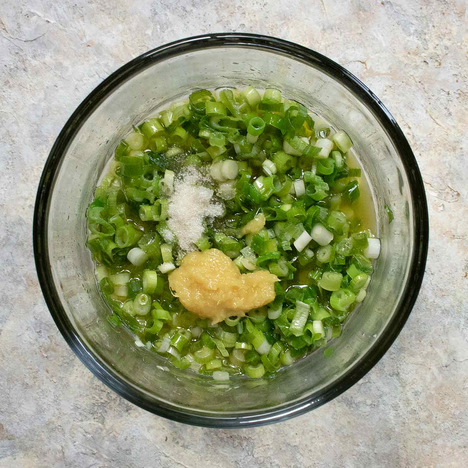 Ginger Scallion Sauce ingredients in a glass bowl.