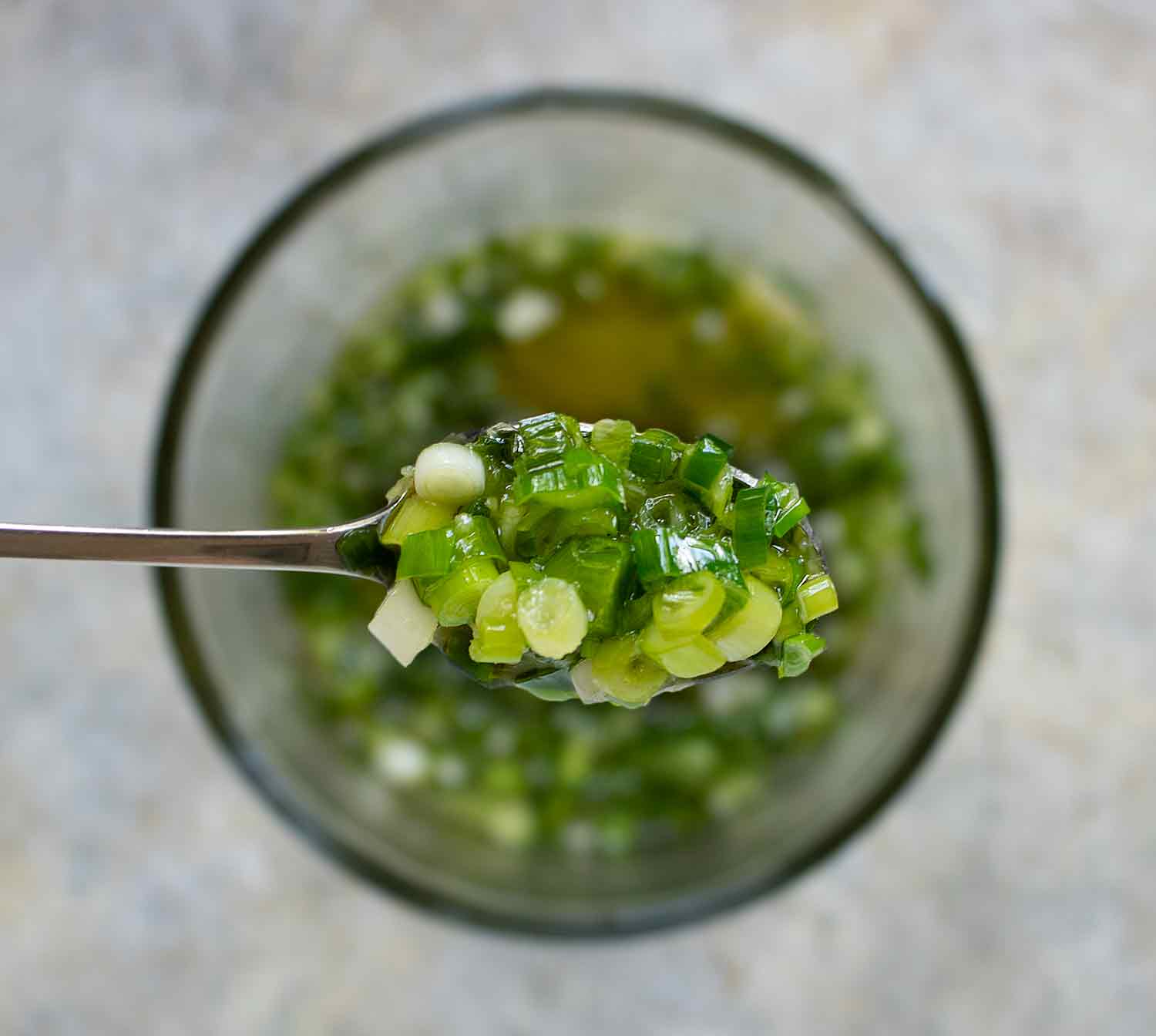 Close-up of Easy Ginger Scallion sauce on a spoon.