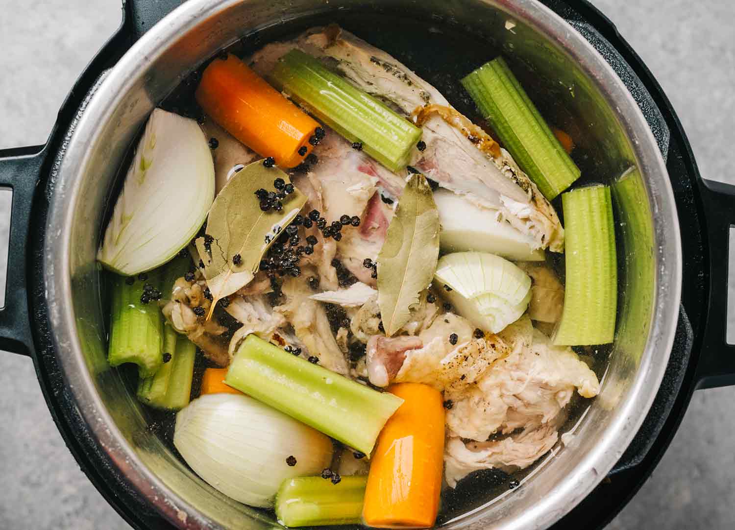 Overhead view of chicken stock ingredients in an Instant Pot.