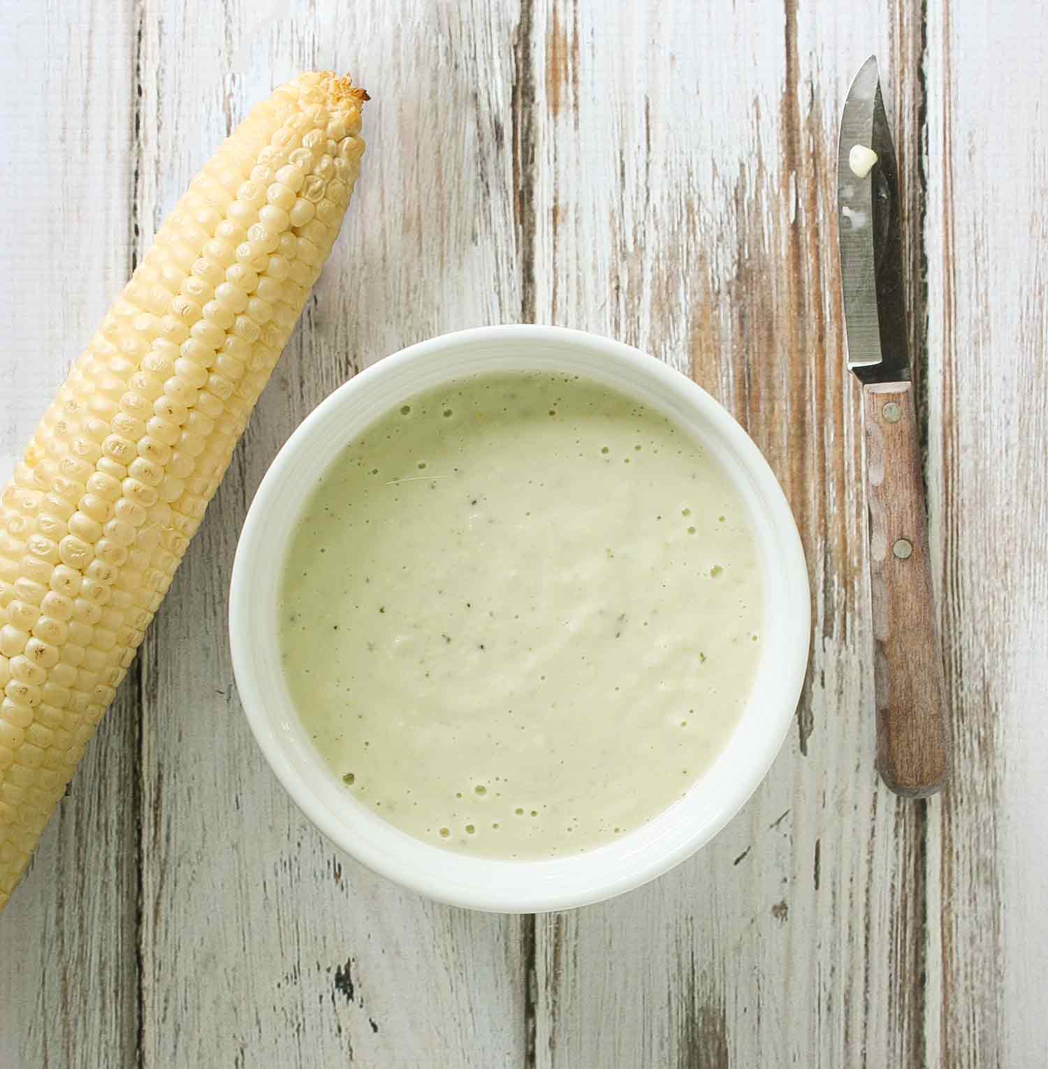 Smoke Corn Mayo in a white bowl with a smoked corn cob to the side.