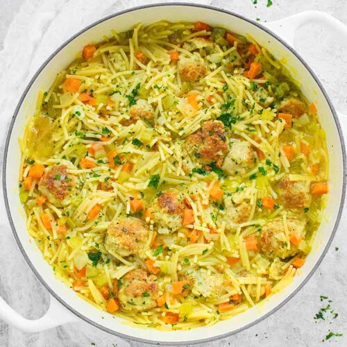 Chicken Meatball Noodle Soup in a white Dutch oven.