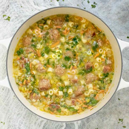 Italian Wedding Soup in a white Dutch oven.