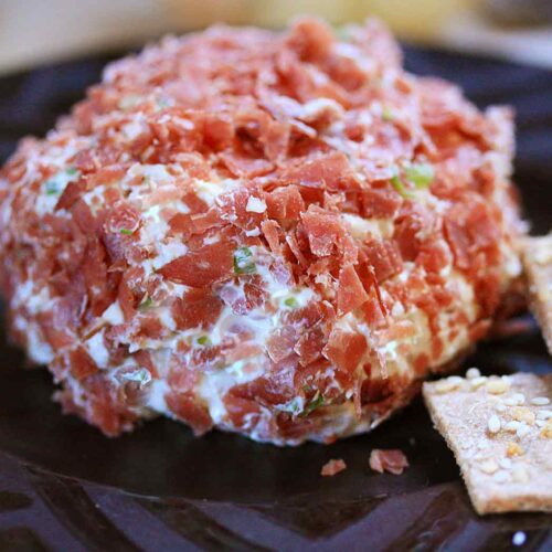 Dried Beef Cheese Ball with crackers on a plate.