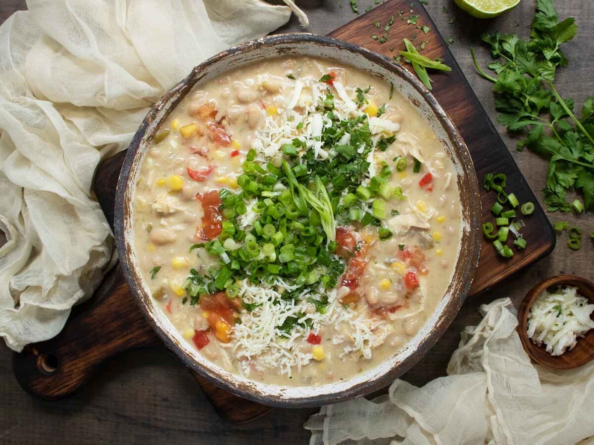 Overhead view of Southwest White Chicken Chili in a rustic bowl.
