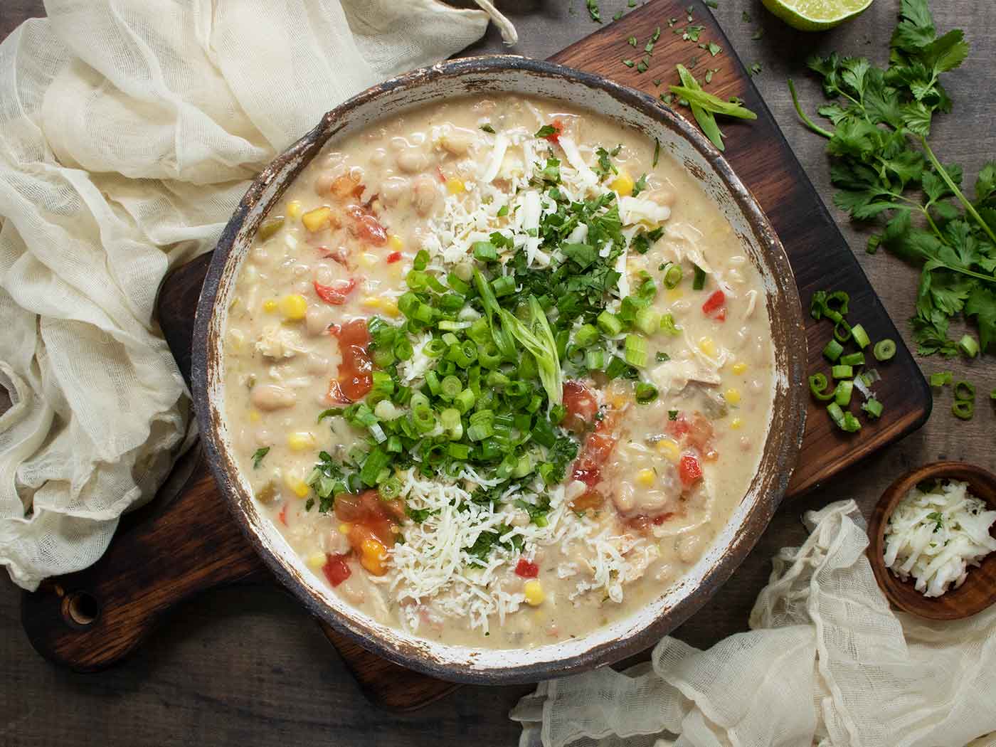 Overhead view of Southwest White Chicken Chili in a rustic bowl.