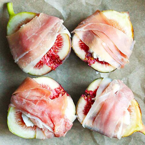 Four Figs Prosciutto on parchment paper, ready to be baked.