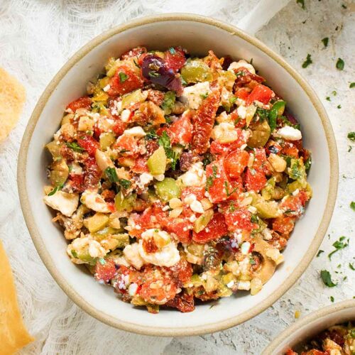 Overhead view of Mediterranean Salsa in a bowl with a side of pita chips.