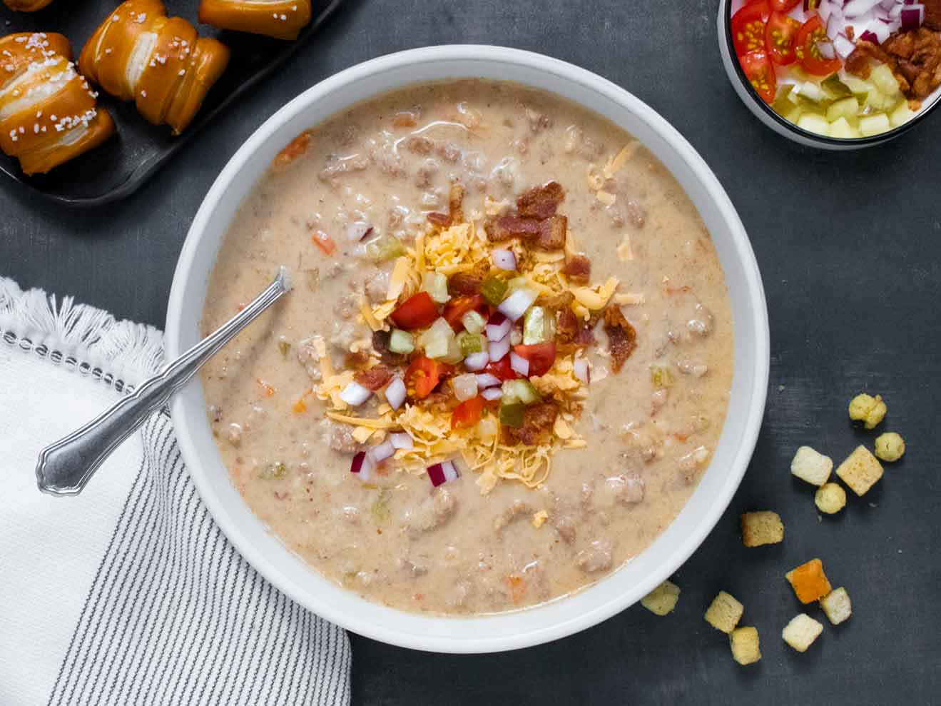 Overhead view of Cheeseburger Beer Soup in a white bowl.
