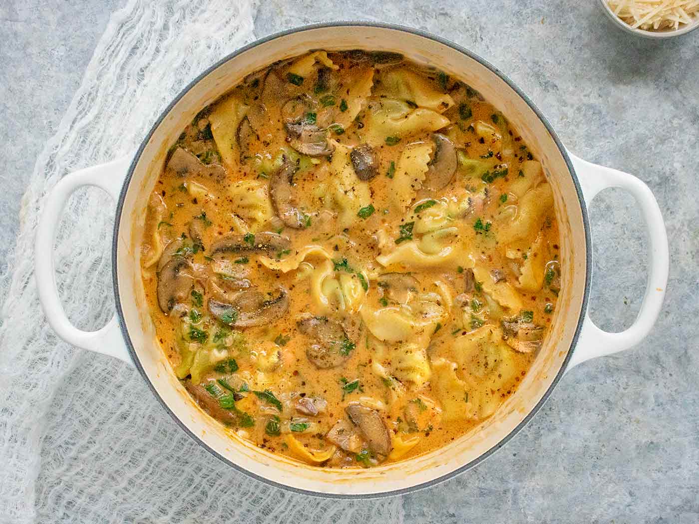 Overhead view of Creamy Mushroom Tortellini Soup in a large soup pot.