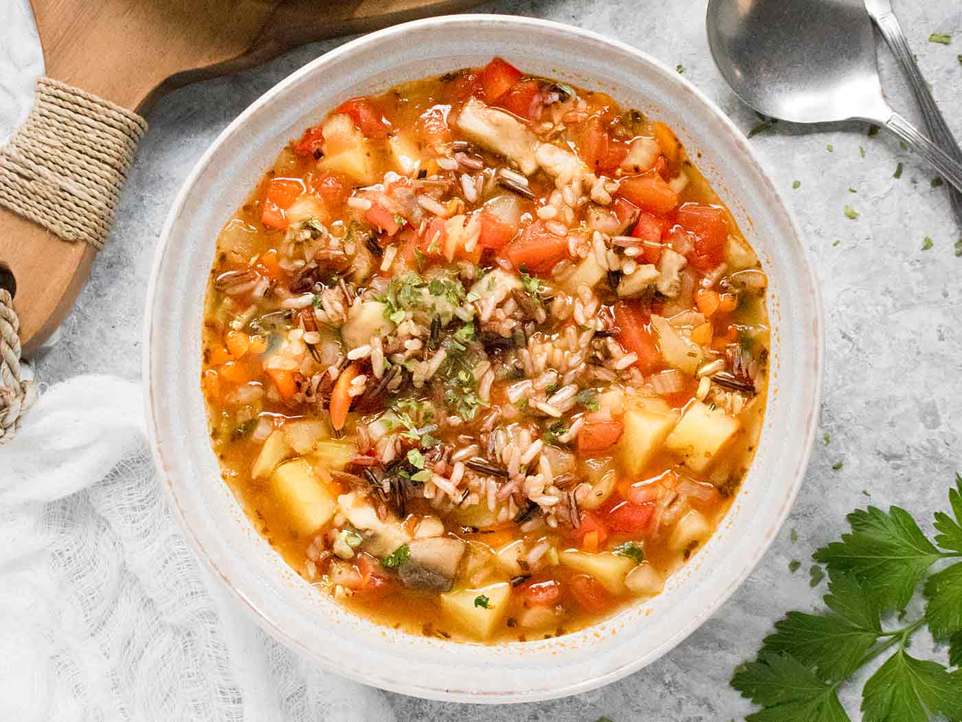 Overhead view of Hearty Vegetable Wild Rice Soup in a white bowl.