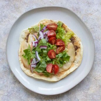 Smash Burger Taco lying flat open on a gray plate.